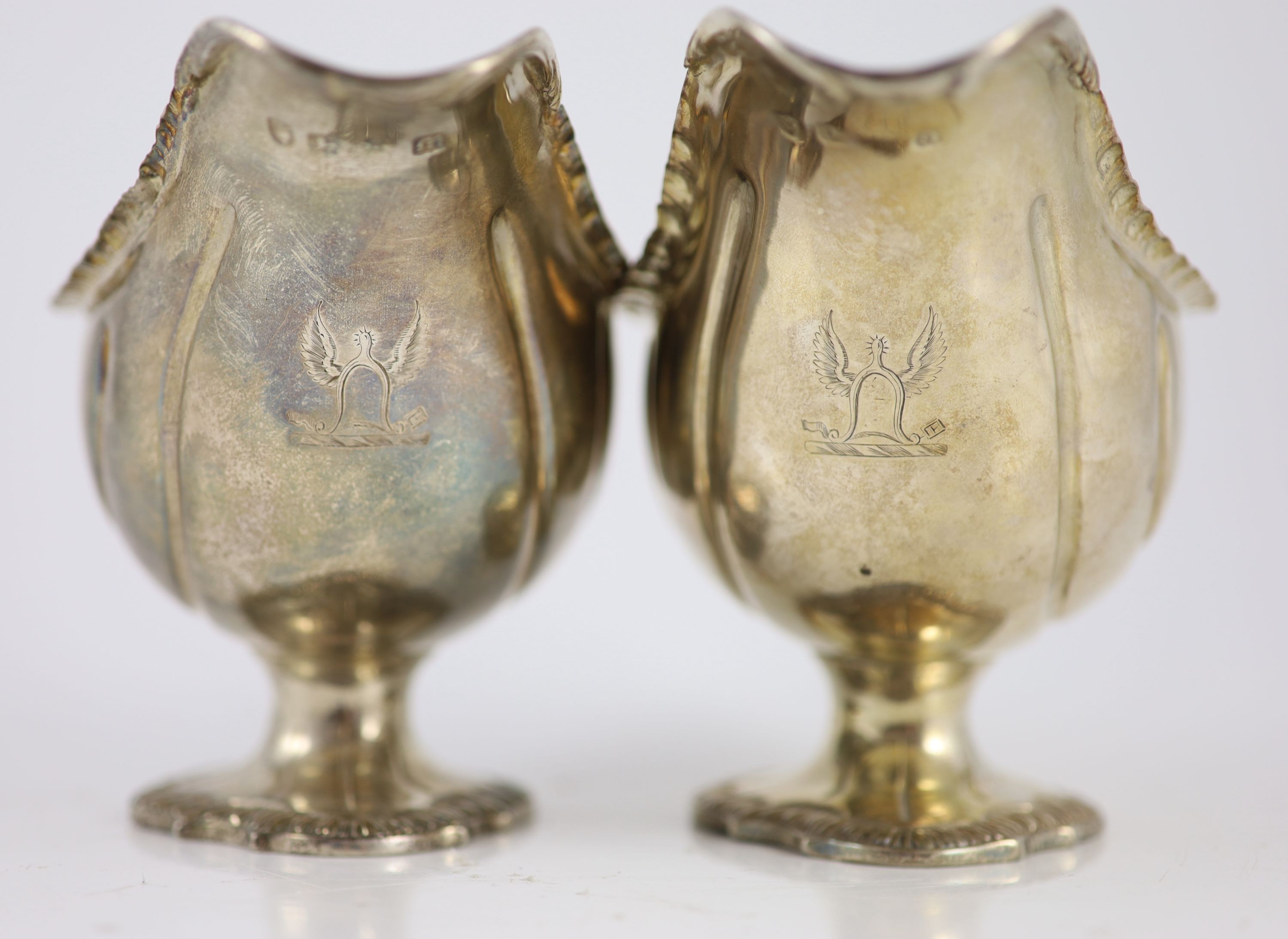 A pair of early George III silver oval pedestal sauce boats by Whyte & Holmes?